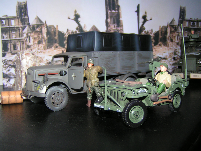 An American soldier inspects the Opel Blitz truck for possible enemy soldiers hiding inside the truck
